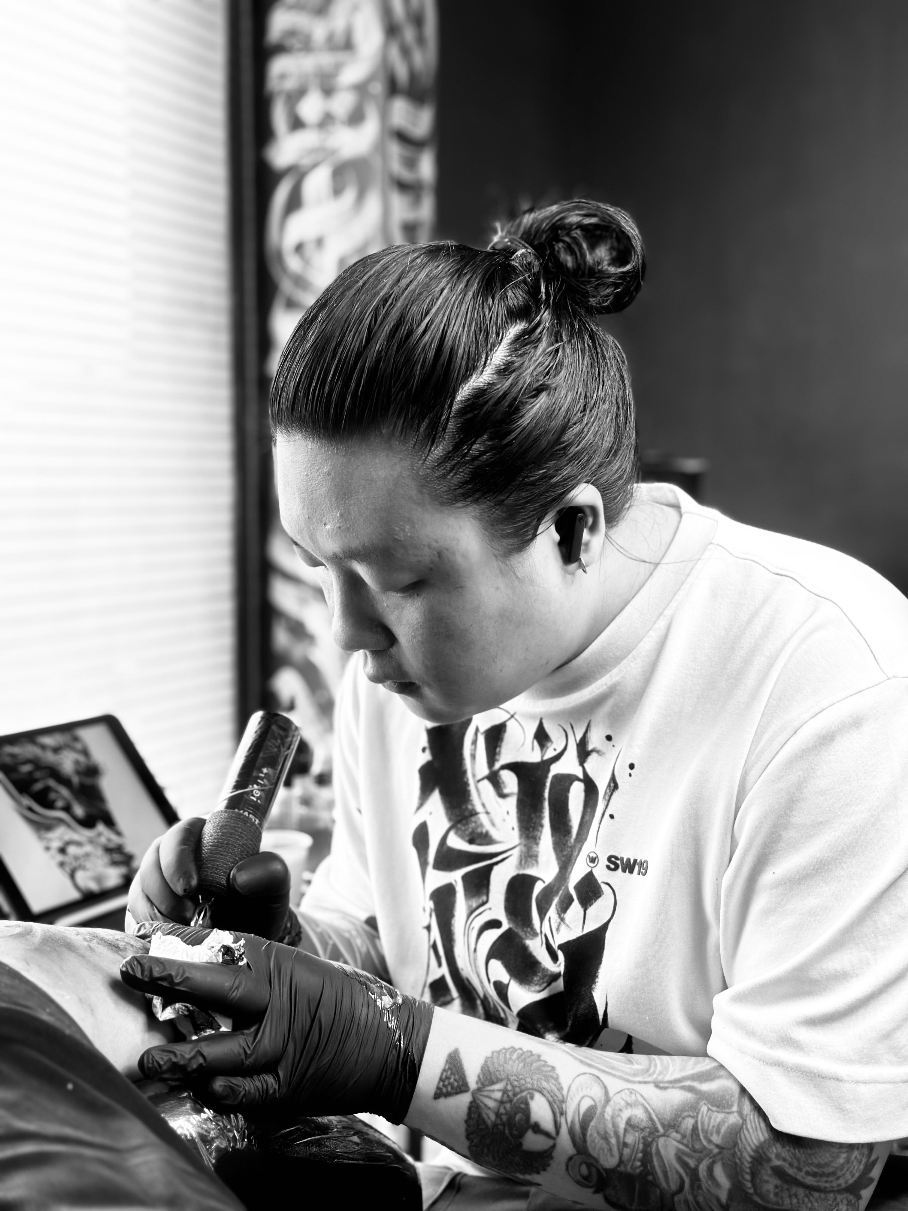 Portrait of Kewal Rai tattooing a client