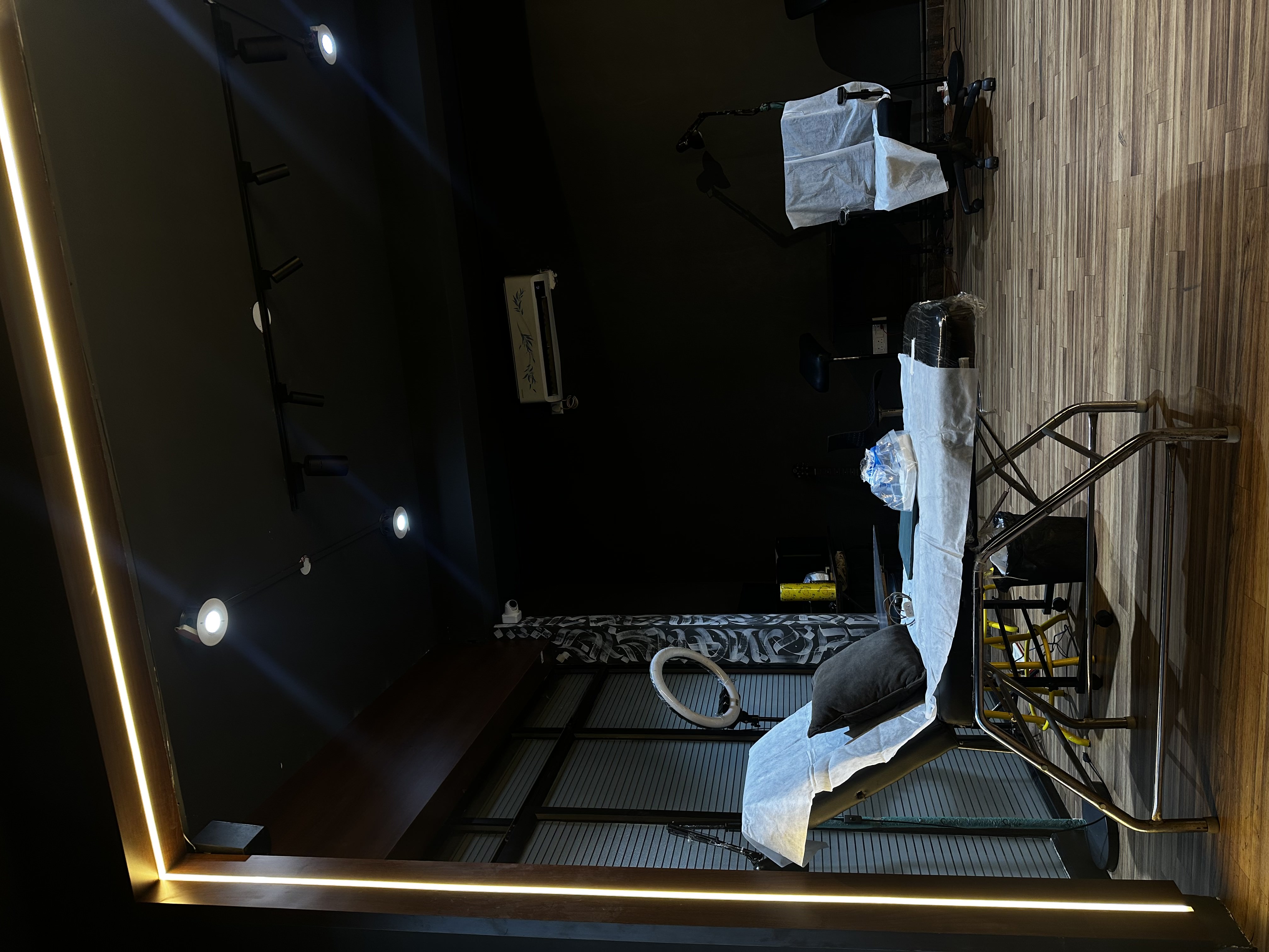 Clean premium booth ready for next client — warm LED and wood floors